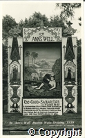 Postcard featuring a black and white photograph of St Ann's Well decorated on the theme of The Good Samaritan for the well dressing festival in 1939.