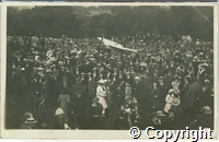 Postcard featuring black and white photograph of crowds surrounding aviator Gustav Hamel's plane in Buxton in August 1912.