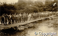 World War One soldiers posing for a photograph on a pontoon bridge on a lake,  in Pavilion Gardens, Buxton, Derbyshire, July 1915