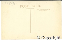 Postcard featuring black and white photograph of a road running under a railway bridge in Buxton.