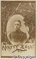 Christmas card: head and shoulders portrait of unknown soldier, framed within a snowy landscape