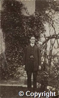 Photograph of "Cloggie" Fewkes in civilian dress, in a garden