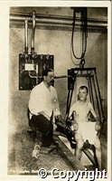 A Cripple's Bath, Devonshire Hospital, with patient in hoisted chair over bath and attendant